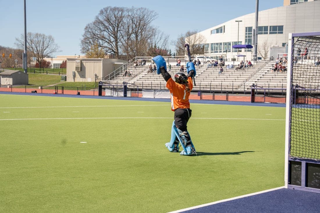 Goalkeeper in orange making a save